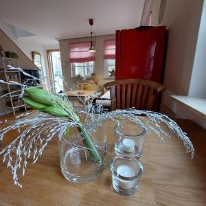 a table with a vase with a flower in it at "NordWest" Ferienwohnung in Prerow
