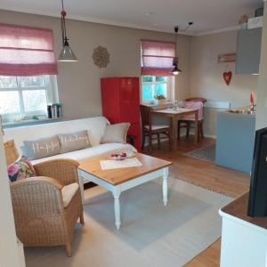 a living room with a couch and a table at "NordWest" Ferienwohnung in Prerow