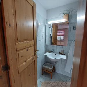 a bathroom with a sink and a mirror at "NordWest" Ferienwohnung in Prerow