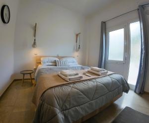 a bedroom with a bed with towels on it at Studios Paleokastritsa - Sun's Gift in Paleokastritsa