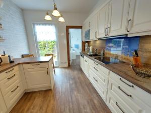 a kitchen with white cabinets and a counter top at Komfortfewo Meeresleuchten in Sassnitz