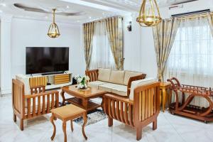 a living room with a couch and a tv at MH - Upper Floor Apart in Douala