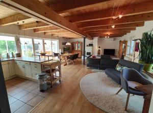 a kitchen and living room with a couch and a table at Ferienhaus Feder in Lichtenau