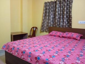 Postel nebo postele na pokoji v ubytování Rukmini Guest House