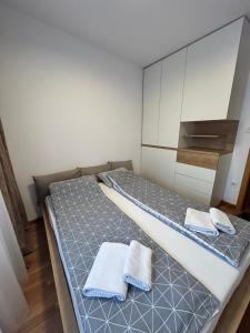 a bedroom with two beds with towels on them at NOVI SAD CITY CENTER in Novi Sad