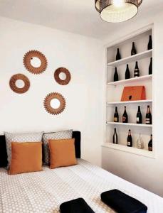 a bedroom with a bed and shelves of wine bottles at Le CoEuR du ViGnObLe Capacité 16 personnes max Venez partager un moment agréable en famille amis couples jeux Pétanque jacuzzi in Épernay +69 photos