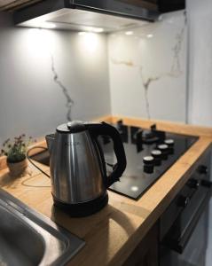 a tea kettle sitting on top of a stove in a kitchen at Studio Astir in Tirane