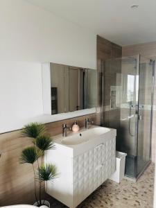 a bathroom with a white sink and a shower at Loft Marina in Cogolin