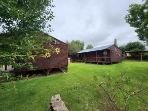 a barn and a house in a yard at Self-catering Unit 6 in Kestell