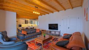 a living room with couches and a table at Villa TEPE in Arsaköy