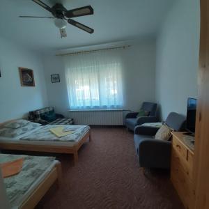 A bed or beds in a room at Rózsa Vendégház