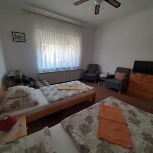 A bed or beds in a room at Rózsa Vendégház