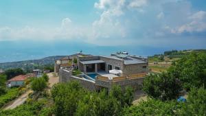 an aerial view of a house with a swimming pool at Villa TEPE in Arsaköy