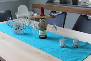 a table with a bottle of wine on top of it at Villa Aquila Luxus-Maisonette Ferienträume Dachterrasse in Göhren-Lebbin