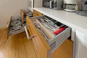 a kitchen with an open drawer with utensils at Lieselhaus in Busenberg +8 photos