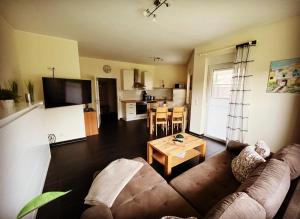 a living room with a couch and a table at Nicky's Ferienhaus in Geeste