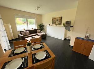 a living room with a table and a couch at Nicky's Ferienhaus in Geeste +14 photos
