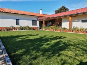 a house with a large lawn in front of it at Castro's guesthouse in Viana do Castelo