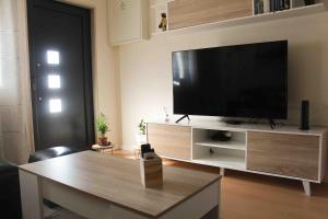 a living room with a large flat screen tv at Castro's guesthouse in Viana do Castelo