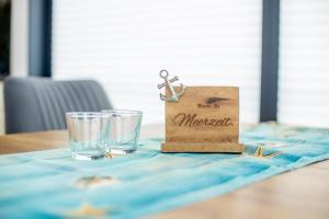 a paper bag and two glasses on a table at Hausboot Träumerei - LP3 in Peenemünde