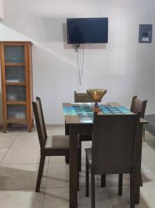 a dining room with a table with chairs and a television at Departamento Flor de María in Ciudad Madero