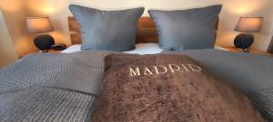 a bed with the word madrid written on it at Apartment Madrid Garten & Pool als Extra möglich barrierefrei in Mühlhausen