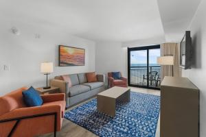 a living room with a couch and a table at Ocean Reef Resort in Myrtle Beach
