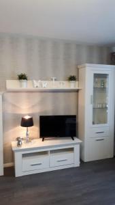 a white desk with a tv on top of it at Fewo 25 in Goslar