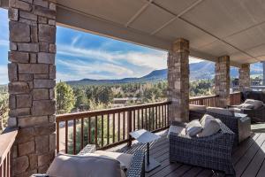 a balcony with chairs and a view of mountains at Elk Rim 1140 Pine in Pine