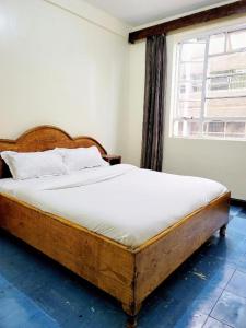 Ένα ή περισσότερα κρεβάτια σε δωμάτιο στο Nairobi City Breeze Suites +29 φωτογραφίες