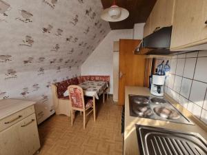 a kitchen with a table and a dining room at Fewo Janssen in Borkum