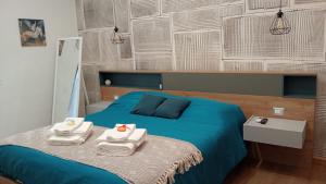 a bedroom with a blue bed with towels on it at Antico Palazzo in Salerno
