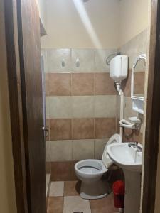 a small bathroom with a toilet and a sink at Casa Rústica para 8 personas in Mar Azul +4 photos