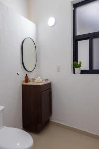 een badkamer met een wastafel en een spiegel aan de muur bij NEW! Aldea Bamboo 3 Terrace & Centro in Cuernavaca