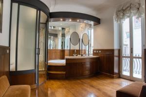 a bathroom with a tub and a large mirror at Orsoline Boutique Apartments - Best position in Rome in Rome +91 photos