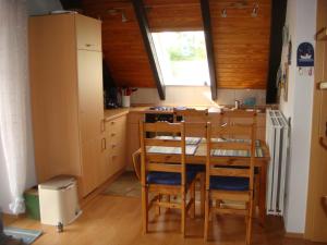 a kitchen with a table and chairs in a room at Fewo Hoogen in Strandnähe in Friedrichskoog-Spitz