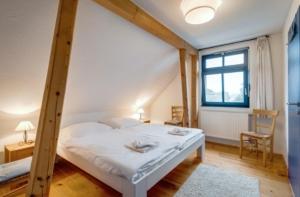 a bedroom with a bed and a window at 3-Raum Dachgeschoss Apartment 54 in Rankwitz