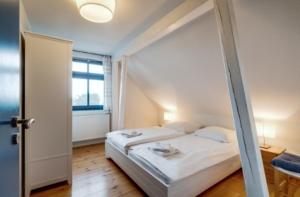 a bedroom with a bed and a window at 3-Raum Dachgeschoss Apartment 54 in Rankwitz