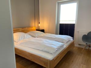 Postel nebo postele na pokoji v ubytování Ferienhaus Sundowner FH6
