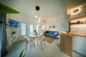 a living room with a table and a blue couch at la belavista in Izola