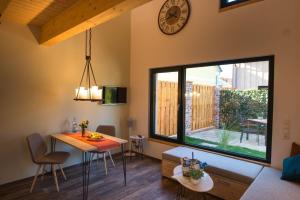 a living room with a table and a large window at Ferienwohnung 2 in Hoyerswerda