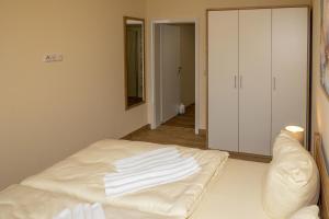 a room with a bed with white towels on it at Seewohnung "Riems" in Gützkow +4 photos