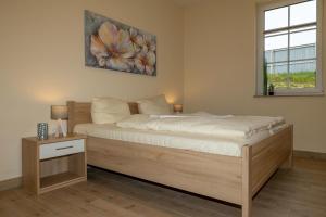 a bedroom with a bed and a window at Seewohnung "Riems" in Gützkow