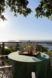 a table with two glasses and a bottle of wine at Minas Em Marambaia in Rio de Janeiro
