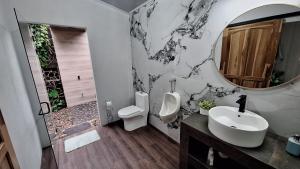 a bathroom with a toilet and a sink and a urinal at Elegant studio in Fortuna +38 photos