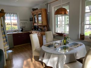 a kitchen with a table and chairs in a kitchen at Ferienhaus Schiffchen "Unter Deck" in Prerow