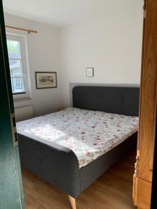 a bedroom with a bed with a quilt on it at Ferienhaus Schiffchen "Unter Deck" in Prerow +7 photos