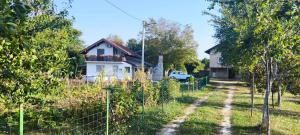 a house with a fence in front of a yard at Villa Seferovka in Kulen Vakuf
