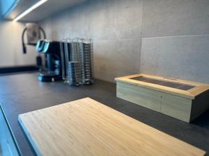a kitchen counter with a wooden box on a counter top at NicePlace4You in Klosterdorf