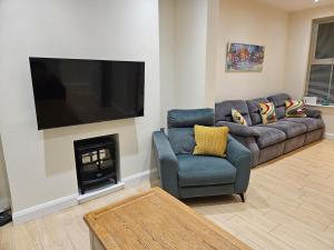 a living room with a couch and a fire place at Forthill Lodge in Enniskillen